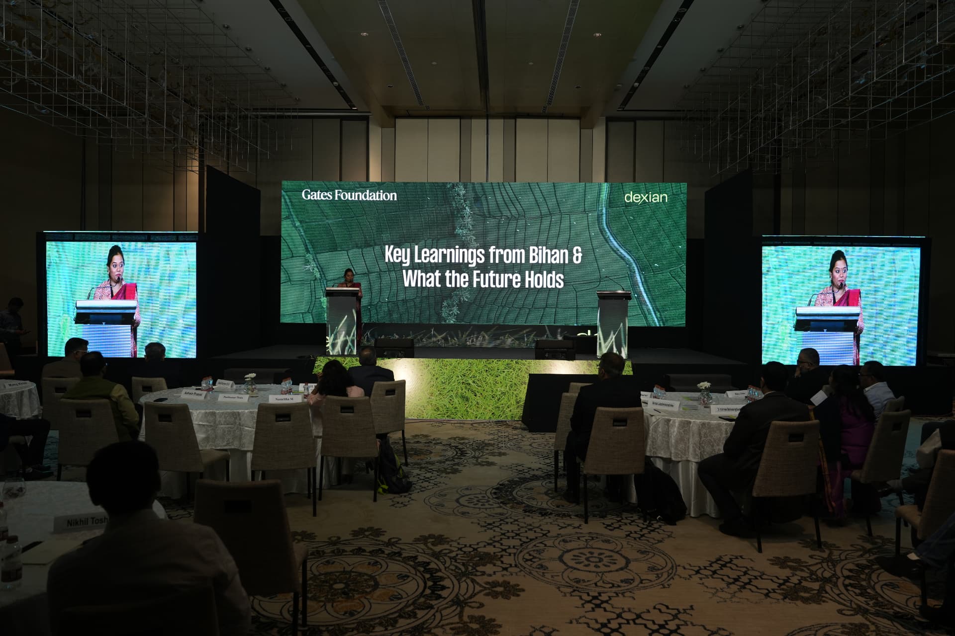 Event hall with audience, stage and side screens