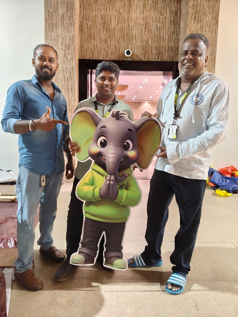 Team holding the program mascot standee